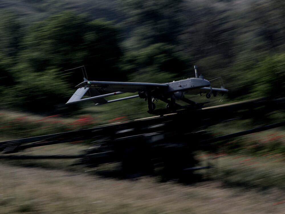 An RQ-7 Shadow uncrewed aircraft launching from its catapult during an exercise